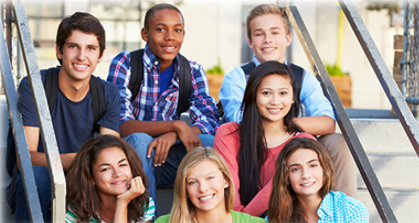 group of kids sitting on steps